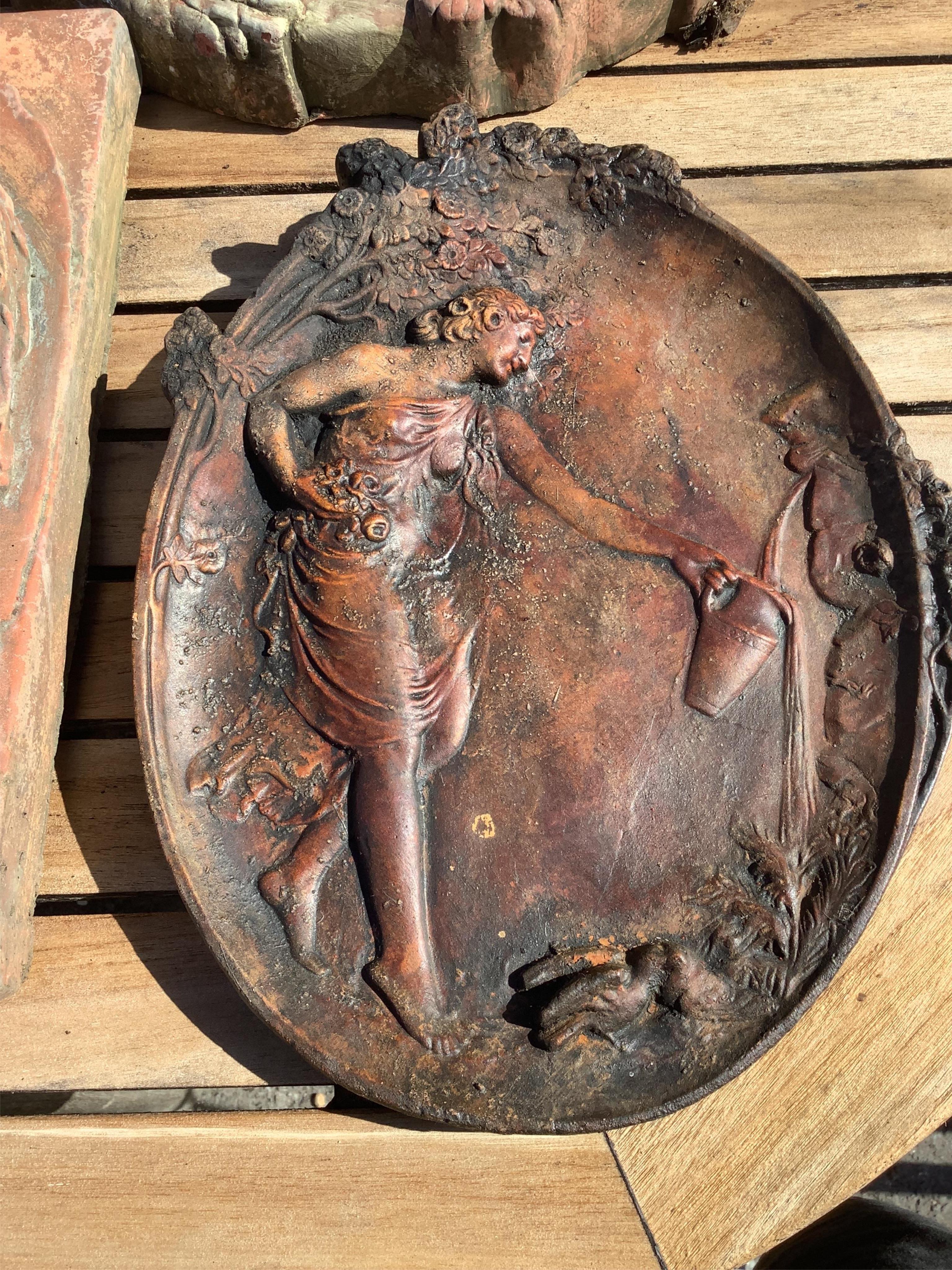 Five cast stone and terracotta garden wall plaques, largest diameter 41cm